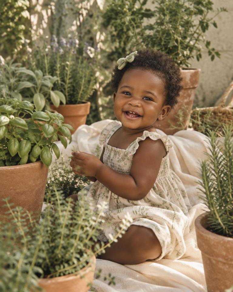 Amara laughing in a garden of herbs